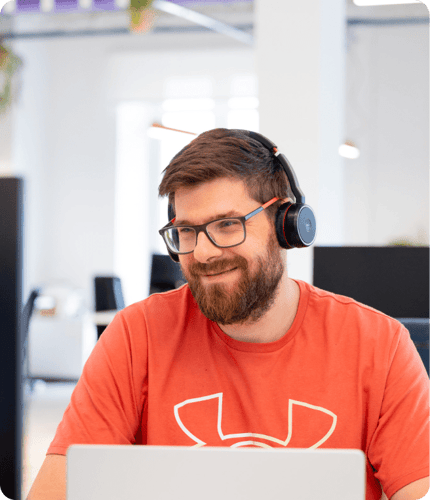 a man smiling while working